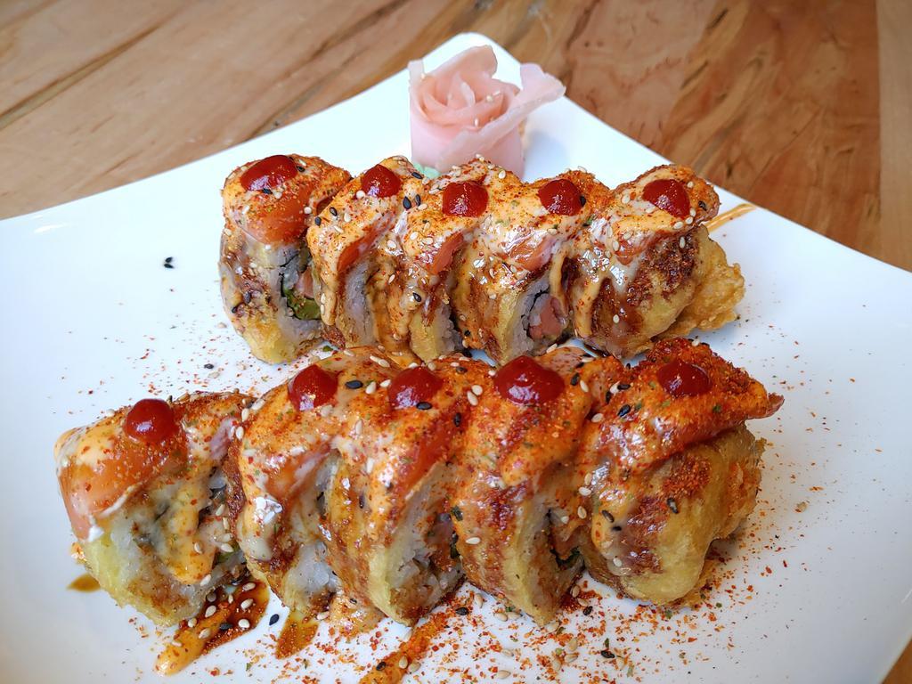 Heaven on Earth Roll · Smoked salmon, cream cheese, jalapeno, avocado inside, deep fried, fresh salmon on top with sesame seeds and 4 kinds of sauces.