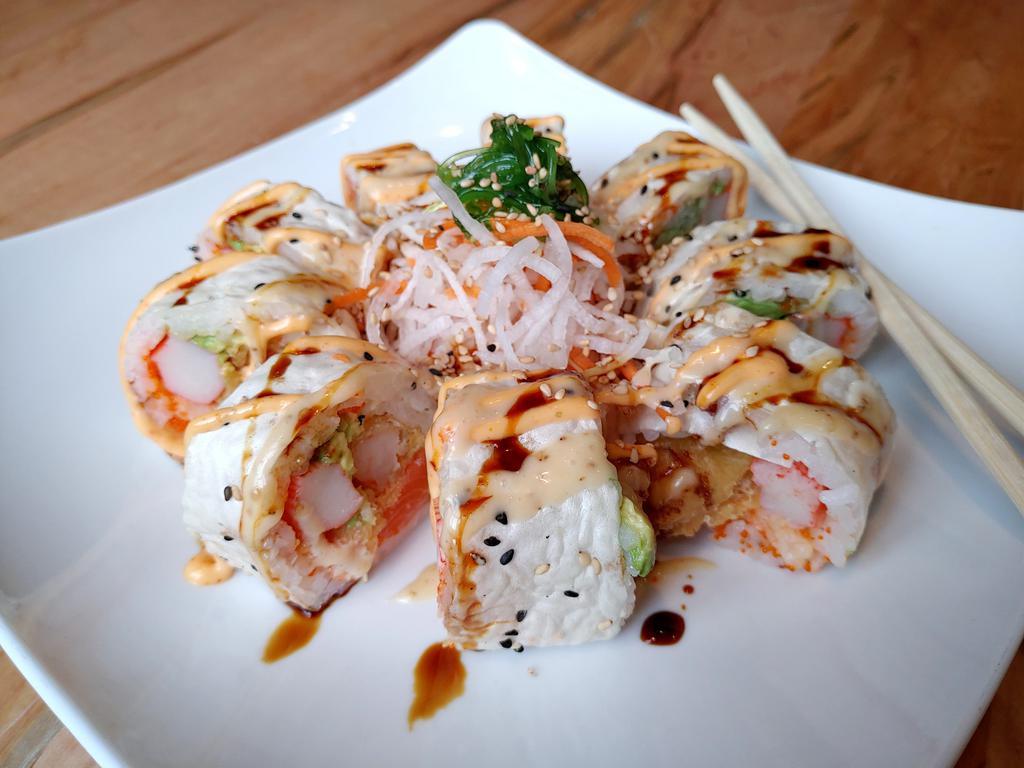 Monster Roll · Salmon, avocado, crab, cucumber, lobster salad, shrimp tempura, flying fish eggs inside and special sauce on top.