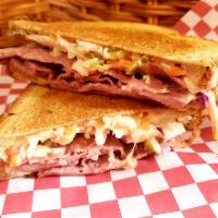 Rachel Sandwich · This sandwich is packed with turkey pastrami, Swiss cheese, our apple blue cheese coleslaw, ...