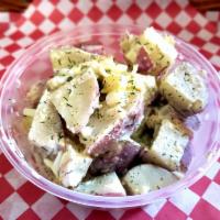 Dillytato Salad · This side dish is created with a mixture red potatoes, hard boiled eggs, onions, pickles, an...