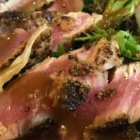 Seared Ahi Salad · Pan-seared ahi, mixed greens, cabbage, pickled ginger pickled red onions, sesame-ginger dres...