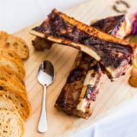 Tommy Lyons BBQ Bone Marrow · Pickled onions, garlic confit and red cabbage slaw.
