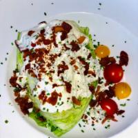 Iceberg Wedge Salad  · Bacon, blue cheese crumbles, cherry tomatoes and ranch dressing.