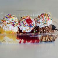 Banana Split · A banana topped with chocolate, vanilla and strawberry ice cream with chocolate syrup, straw...