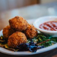 Risotto Bites (Arancini) · House-made arancini with risotto, prosciutto, roasted red peppers and provolone. Deep-fried ...