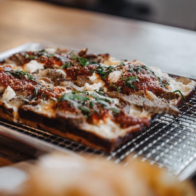 DSP The Meatball · Garlic olive oil, 4 cheese blend, tomato sauce, fresh basil, pecorino, sliced meatballs, ricottacheese. The Motor City meets the Salt City for our take on Detroit Style Pizza. A crispy, chewy, cheesy pan pizza baked in a traditional Bakers Pride pizza oven. All DSP's are 10