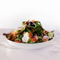 Fattoush Salad · Fresh greens with chopped tomatoes, cucumbers, red onion, radish, mint, pita chips in a pome...