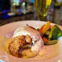 Country Fried Chicken · Hand-breaded chicken breast, country gravy served on a bed of creamy mashed potatoes with st...