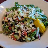Greek Salad · Fresh mixed greens, black olives, cucumbers, onion and diced tomatoes served with a Greek vi...