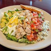 TDC Cobb Salad · Crispy romaine served with Green Goddess dressing, topped with egg, bacon, tender grilled ch...