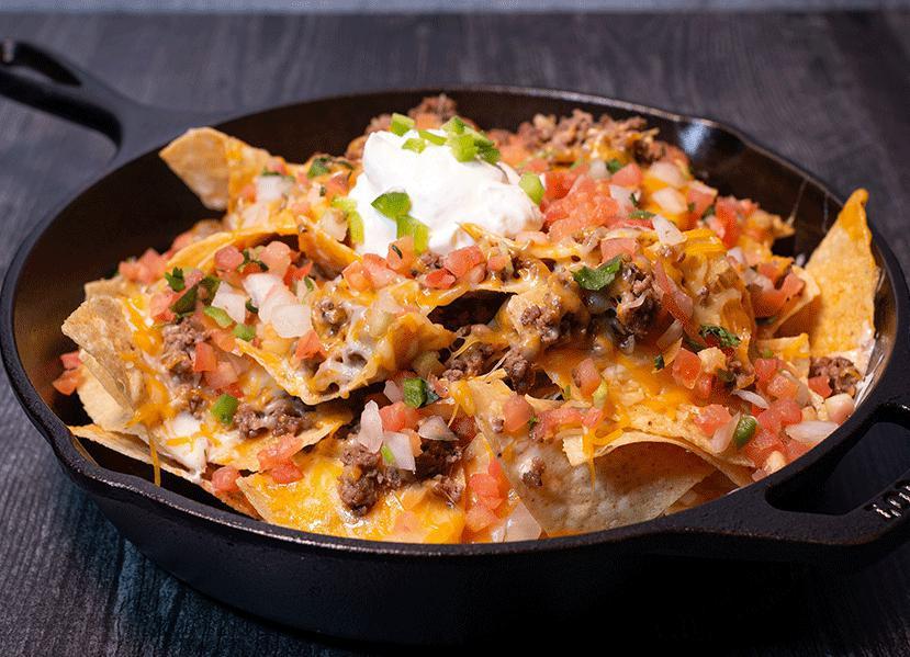 Nachos · Piled high with cheese, pico de gallo, queso, sour cream and jalapenos. Add guacamole for an additional charge.