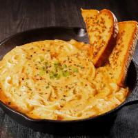 Cajun Chicken Pasta · Creamy fettuccine noodles smothered in our zesty Alfredo sauce with a side of garlic toast. ...