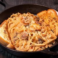 Pasta Mardi Gras · Creamy fettuccine noodles smothered in our zesty Alfredo sauce with shrimp, crawfish, sausag...