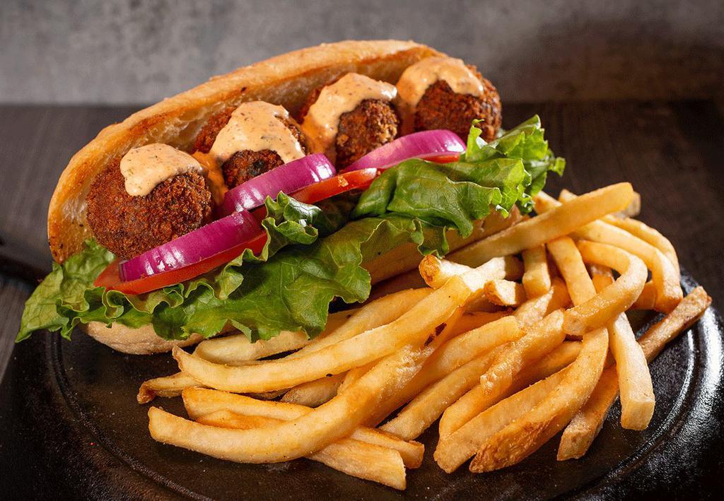 Cajun Boudin Po Boy · 4 large boudin balls perfectly fried with 242 zesty sauce served on a toasted buttered hoagie roll with lettuce tomato and onion.