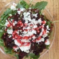 Stefanie’s Salad · Fresh arugula, crushed walnuts, dried cranberries, feta with fat-free raspberry vinaigrette.