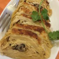 15. Veggie Duck · Fragrant mushroom filling wrapped with layers of tofu skin. 