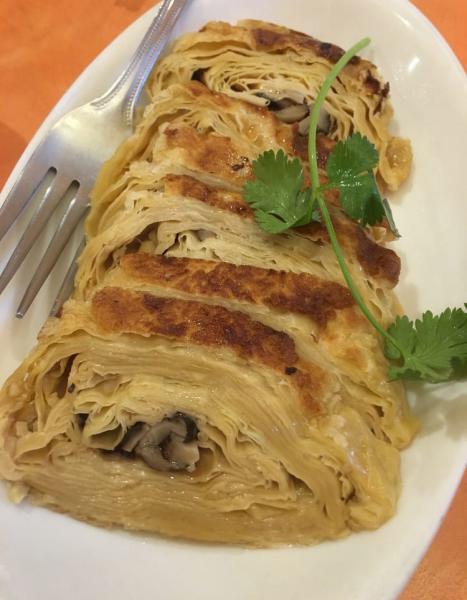 15. Veggie Duck · Fragrant mushroom filling wrapped with layers of tofu skin. 