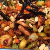 Spicy Kung Pao Chicken · Spicy chicken stir fried with celery, zucchini, carrots, water chestnuts, peanuts, and toppe...