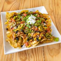 BBQ Chicken Nachos Lunch · Served with 4-cheese blend, tomatoes, slow-cooked BBQ chicken, Costa Rican black beans, roas...