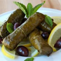 11. Small Grape Leaves · Grape leaves stuffed with rice, dry mint, black pepper and onions.