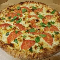 Tomato Basil Pizza · No red sauce, just extra virgin olive oil, garlic, mozzarella cheese, sliced tomato and fres...