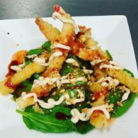 Spicy Garlic Shrimp · Shrimp tempura served over spring mix, crispy onions and finished with spicy chili, soy sauc...