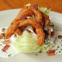 Classic Wedge salad · Iceberg wedge topped with bacon bits, fried onions and house blue cheese or ranch.