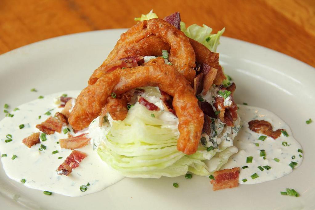 Classic Wedge salad · Iceberg wedge topped with bacon bits, fried onions and house blue cheese or ranch.