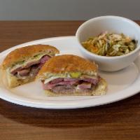 Cubano Sandwich · Roasted pork, carved ham, yellow mustard sauce, Swiss and pickles on a baguette.