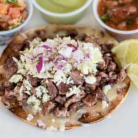 Steak Tostada · Crisp corn tortilla topped with melted Monterey Jack cheese, mesquite grilled carne asada, d...