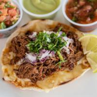 Birria Tostada · Crisp corn tortilla topped with melted Monterey Jack cheese, shredded beef, diced red onion ...