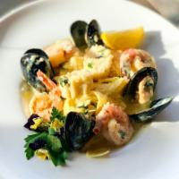 Seafood Pappardelle Pasta · Shrimps, mussels and scallops with creamy white sauce and Parmesan cheese