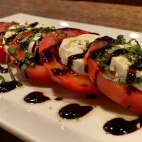 Mozzarella Caprese · Slices of homemade fresh mozzarella, tomatoes, fresh basil and drizzled with olive oil and a...