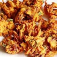 Onion Pakora · Thinly-sliced onions battered with chick-pea flour and spices and deep fried. A very popular...