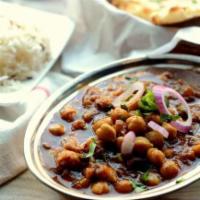 Channa Masala · Garbanzo beans cooked with Indian spices and tomatoes and onion sauce.