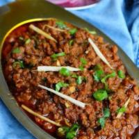 Goat Kheema Masala · Minced mutton cooked in delicately ground spices and onions. Served with choice of butter na...