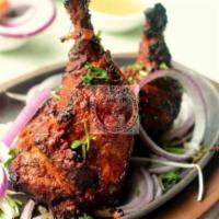 Tandoori Chicken (Half) · Grilled bone-in chicken marinated in yogurt, garlic, ginger, ground spices and grilled in Ta...