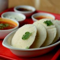 Idli · Steamed rice and lentil patties served with savory chutneys and side of sambar