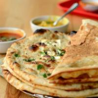 Garlic Naan · Bread made in tandoor oven is topped with minced garlic