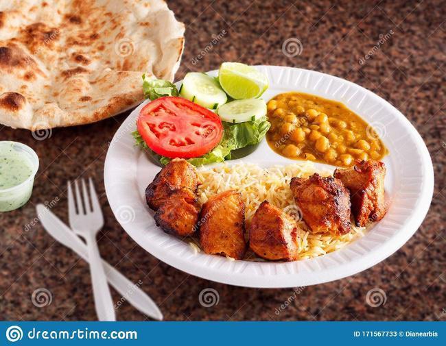 Chicken Tikka Kabob Platter · Lunch portion of Bawarchi Chicken Tikka Kabob served with Basmati Rice, Chick Pea Curry, Naan, Raitha and a chef's special dessert.