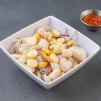Ceviche Clasico · Fish ceviche is served cold and marinated with freshly squeeze limes, blended with Peruvian ...