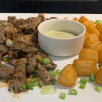 8oz Piece Steak & Yucca · Steak (picanha) sauteed with onions served with fried yucca and cilantro garlic sauce.