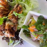Soft Shell Crab Salad · Fried soft shell crab served over a green mango salad spicy lime dressing.