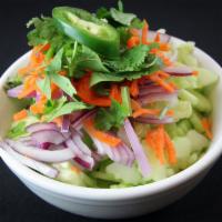 Cucumber Salad · Sliced cucumbers, red onions and shredded carrots topped with a tart vinaigrette dressing.
