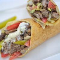 Beef Shawarma Wrap · Beef roasted on a spit with traditional herbs & spices served in pita wrapped with garlic bu...