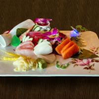 11. Sashimi Deluxe · 18 pieces of sashimi and sushi rice. Served with miso soup and salad.