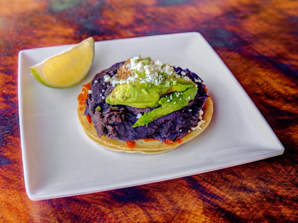Queso y Frijoles Taco · Blend of asadero y Cotija, black bean puree, chipotle salsa, avocado. Served on racquets white corn tortillas. Melted cheese dip. 