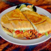 Torta el Gallo Negro · Smoked chicken, asadero cheese, and salsa ranchera served on telara rolls with romaine, slic...