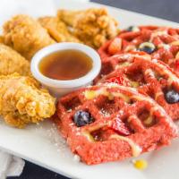 Chicken and Red Velvet Waffles · Red velvet waffles topped with fresh strawberries, blueberries and powdered sugar. Served wi...