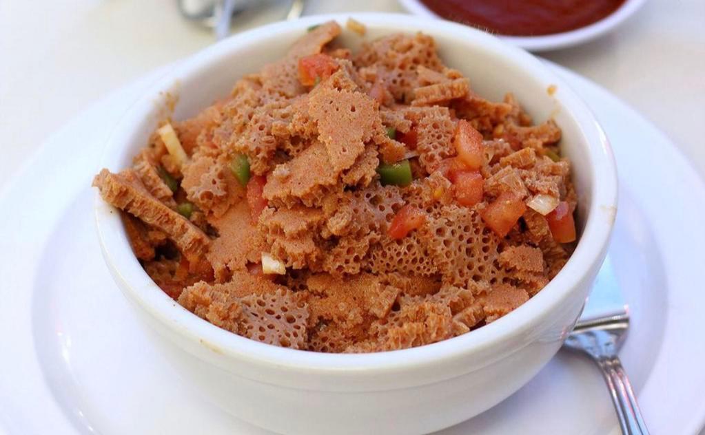 38. Timatim Fitfit · Finely chopped tomatoes jalapeno and onion flavored with lemon-based house seasoning mixed with injera pieces.